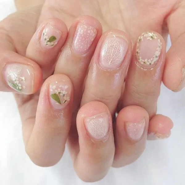 Bring nature to your fingertips with delicate spring flower nail art.